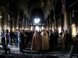 Iraqi priests hold the first Sunday mass at the Grand Immaculate Church since it was recaptured from Islamic State in Qaraqosh, near Mosul