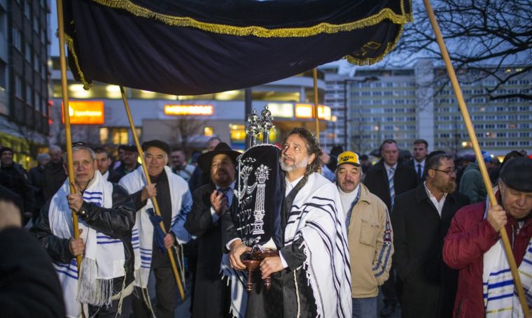 A member of the Jewish community carries Torah scrolls during the dedication service of the new synagogue in the former church in Cottbus.