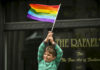 A young boy waves a rainbow flag while watching the San Francisco gay pride parade