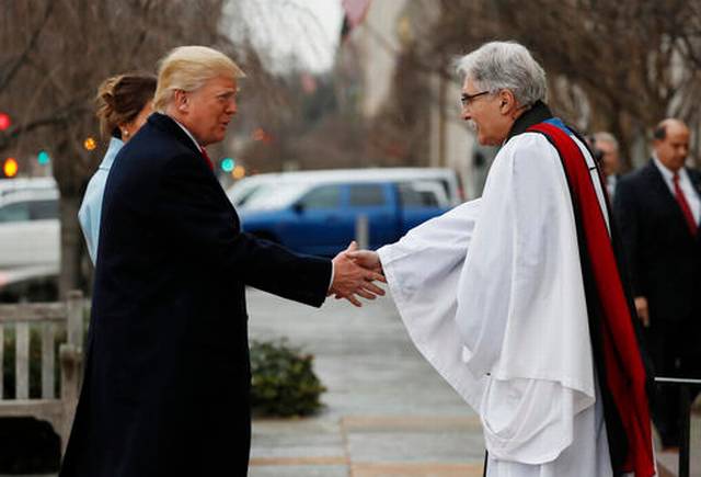Rev Luis Leon greets President-elect Donald Trump and his wife Melania as they arrive