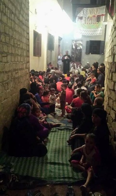 The Copts congregate in an alleyway to pray.