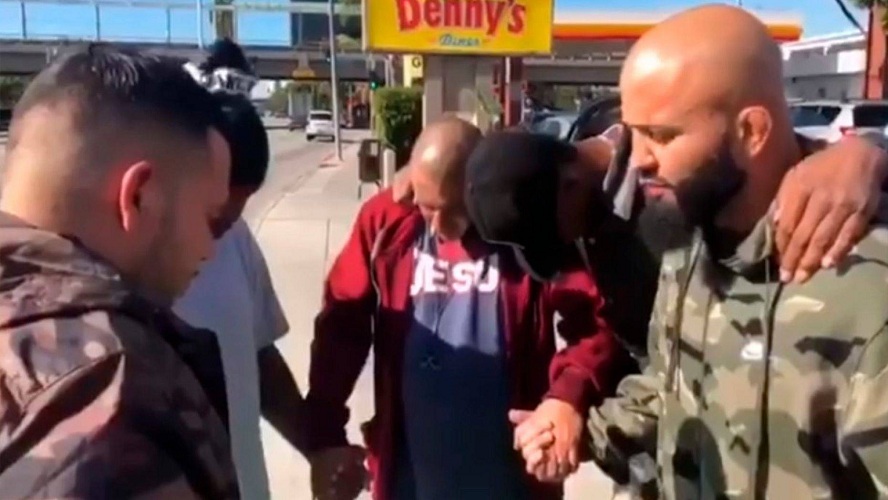 Rene "Level" Martinez praying with others on the streets of Los Angeles with his ministry "One Accord."