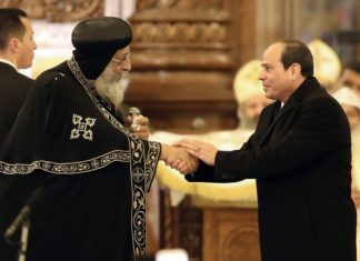 Pope Tawadros II (L) led a midnight mass attended by President Abdel Fattah al-Sisi (R)