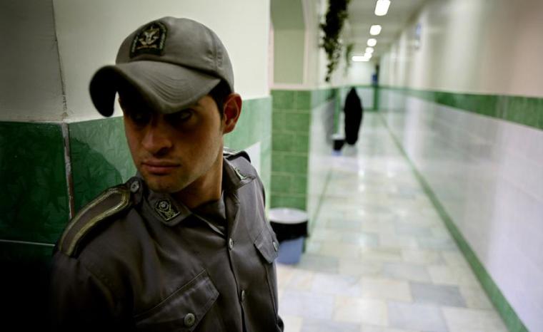 A prison guard stands along a corridor in Tehran's Evin prison.