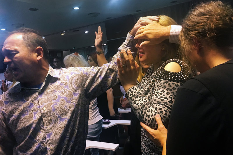Pastor Karl Vickery prays for the Iranian refugee converts in a makeshift church for the United Pentecostal congregation in Denizli, Turkey.