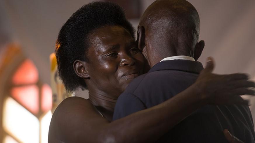 A Genocide survivor, Anne-Marie Uwimana, hugs Celestin Habinshuti, a former Genocide convict who brutally killed two of her children during the 1994 Genocide against the Tutsi.