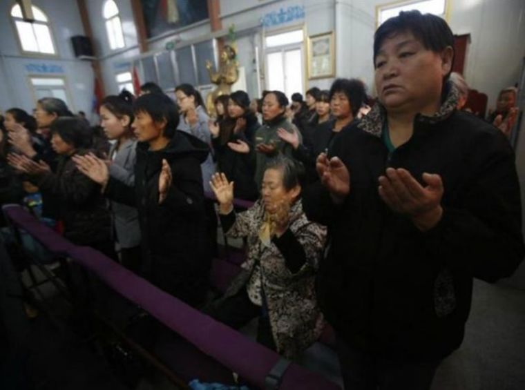 Chinese Christians pray at an underground church in Tianjin
