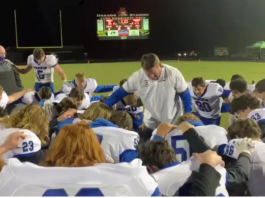 Football Coach Leads Team in Prayer