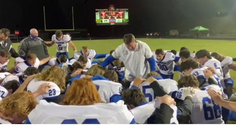 Football Coach Leads Team in Prayer