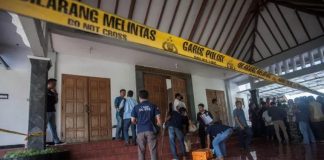 Police are seen outside the Lidwina Catholic Church after a knife-wielding attacker wounded four church-goers in Sleman, Yogyakarta, Indonesia, on February 11, 2018